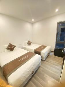 a room with two beds and a window at GOODTECH LUXURY Hotel & Apartment in Danang