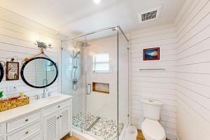 a white bathroom with a shower and a toilet at Tollgate Tides in Islamorada +21 photos