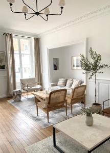 a living room with a couch and a table at La Place B&B in Sancerre