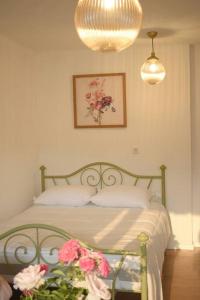 a bedroom with a bed with pink flowers on it at Traveler’s home in Visoko