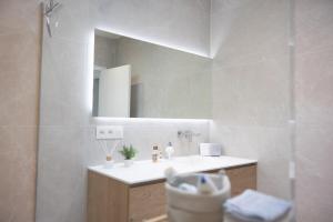 a bathroom with a sink and a mirror at Brand New Apartment Sint-niklaas in Sint-Niklaas