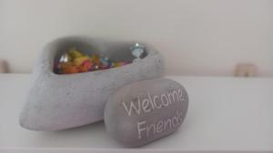 a heart shaped rock next to a container of candy at Monolocale Azzurra in Magione