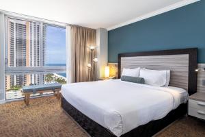 a bedroom with a large bed and a large window at Marenas Beach Resort in Sunny Isles Beach