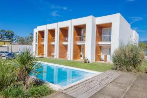 a house with a swimming pool in front of it at Yerba Buena Lofts - Monoambiente con Cochera in Yerba Buena