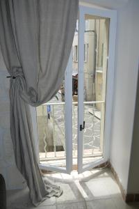 an open door to a balcony with a window at Vieille Ville 1 - Luca's Apartment, 1 bedroom, max 2 adults and 2 kids in Antibes