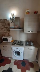 a small kitchen with a stove and a sink at Apartment Cecina in Cecina