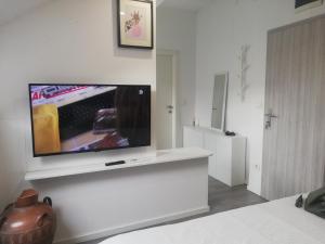 a living room with a flat screen tv on a wall at Apartments Simple Teslina in Zagreb