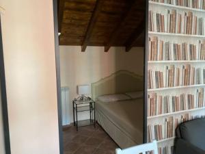 a mirror reflecting a bedroom with a bed and a table at La Corte di Vicolo Torre in Uboldo
