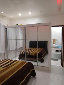 a bedroom with two beds in a room at Casa em Praia Grande Litoral sul in Praia Grande