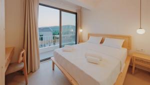 a bedroom with a large bed and a large window at Villa Neo with 2 private pools, bbq, jacuzzi and sauna in Fethiye