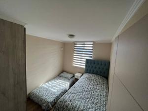 比亞里卡的住宿－Departamento en Villarrica，一间卧室设有两张床和窗户。
