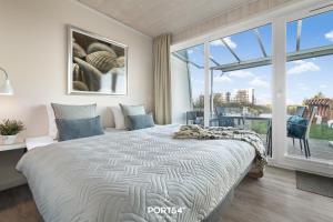 En eller flere senge i et værelse på Ferienhaus Ankerplatz Marina Wendtorf