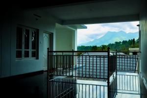 a balcony with a view of a mountain at ADONAY INN RESIDENCY in Kalpetta