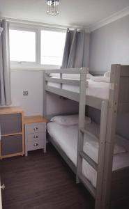 a bunk bed with two bunk beds in a room at Immaculately Presented Detached Family Chalet - 5 mins to beach, nr Great Yarmouth & Norfolk Broads in Great Yarmouth