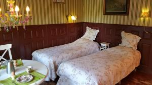 a room with two beds and a table with a tray of food at Bed and Breakfast Het Oude Bos in Wijnjewoude