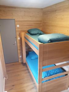 a bunk room with two bunk beds in it at Chalet Jaune Le GRAND SOM in Sarcenas