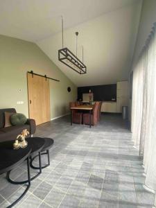 a living room with a couch and a table at Ut-Huuske in Westerbeek +20 photos