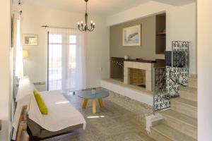 a living room with a couch and a fireplace at Trochalo Villas 2 in Stoupa