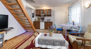 a living room with a staircase and a kitchen at Türi Holiday Home, a simple house in Türi