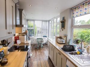 a kitchen with a large window and a dining room at Moelwyn View Cottage in Blaenau-Ffestiniog