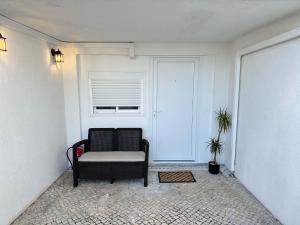 a living room with a chair and a window at MàHouse GuestHouse in Lisbon