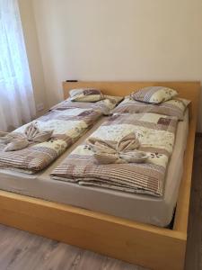 ハイドゥソボスローにあるMimi Apartmanのベッド2台(上部に毛布と枕付)