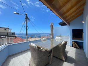 a dining room with a view of the ocean at Tides proprety - High tide in Paul do Mar