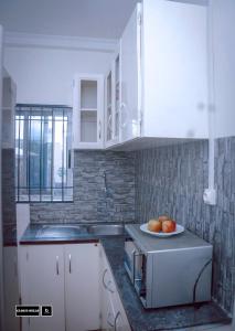 a kitchen with a plate of fruit on a counter at Cloud Hill in Buea