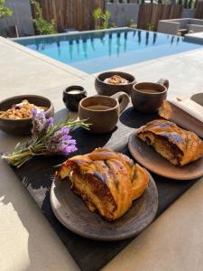 a table with two plates of pastries and bowls of sauce at Casa Michaus Valle de Guadalupe in Valle de Guadalupe