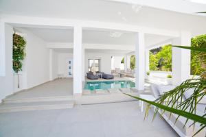 an open living room with a pool and a house at Almyra Seaside Luxury Suites in Kalymnos