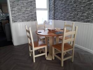 a wooden table and chairs in a kitchen at Sea La Vie in Warrenpoint