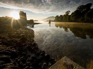 a castle on the shore of a body of water at Sea La Vie in Warrenpoint
