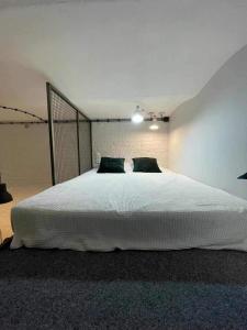a bedroom with a large white bed in a room at Łódź You Like in Łódź