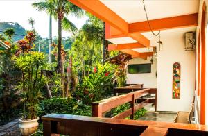 a balcony with a bench and a stained glass window at Feiticeira Praia Hotel in Ilhabela