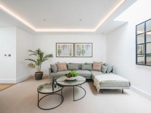 a living room with a couch and a table at Pass the Keys London Modern EcoTownhouse Dulwich in London