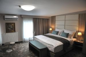 a hotel room with a large bed and a window at Hotel VIP in Sarajevo