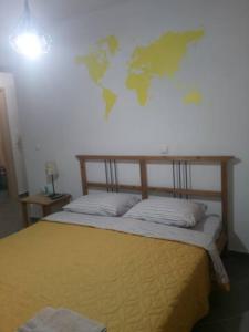 a bedroom with a bed with a world map on the wall at Makis rooms C in Missolonghi