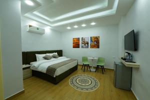 1 dormitorio con 1 cama, mesa y sillas en simple street apartment en Wadi Musa