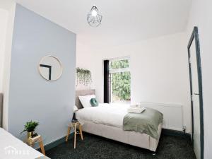 a white bedroom with a bed and a window at BIRMINGHAM HOME : STYLISH : WELCOMES ALL in Birmingham