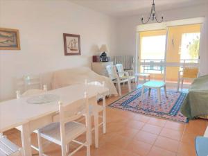 a kitchen and living room with a table and chairs at Desertrose in Porto Santo
