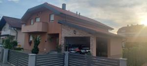 a house with a car parked in the garage at Marina in Sesvete