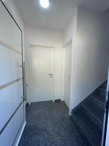 an empty hallway with two white doors in a building at Tides proprety - High tide in Paul do Mar