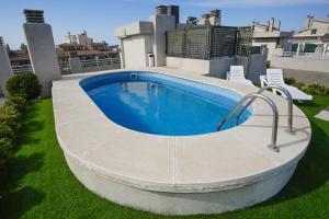 a swimming pool on the side of a house at MAEVA HomeStay by Turismar in Cambrils