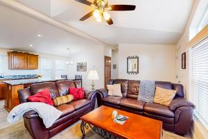 a living room with a leather couch and a table at Apache Abode in Show Low