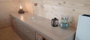 a wooden counter with glasses and candles on it at Y Nyth - The nest in Bridgend