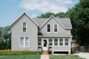 a gray house with a white front door at Downtown & Campus Wifi W D Netflix 2Br 1Ba in Ames