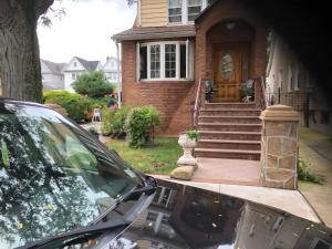 a car parked in front of a house at Room to stay in in South Ozone Park
