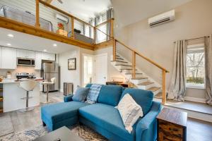 a living room with a blue couch and a staircase at West Atlanta Craftsman Studio with Front Yard! in Atlanta