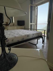 a bed in a room with a window at VILLABRI in Maratea
