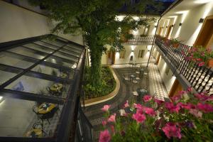 an overhead view of a courtyard with pink flowers at Hotel At the White Lily in Prague